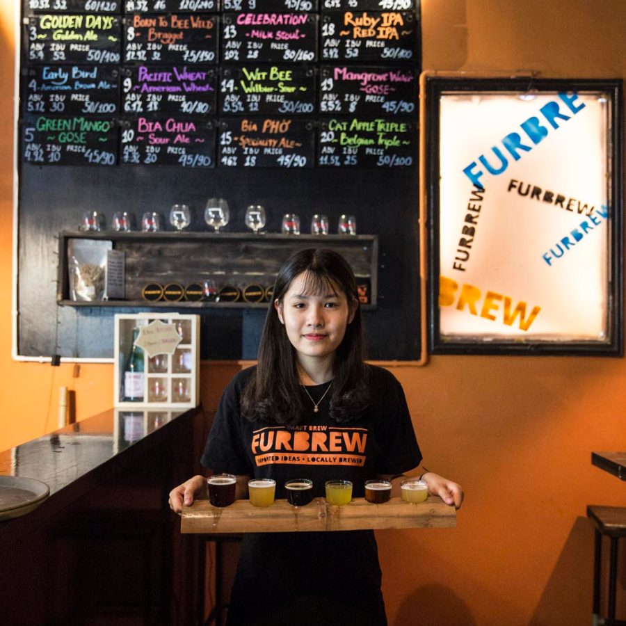 Woman holding a beer flight