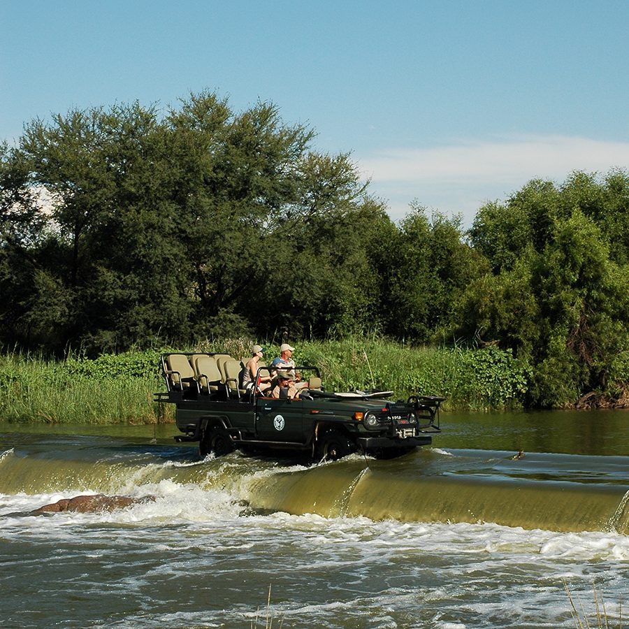 Mziki Private Game Reserve vehicle going through water