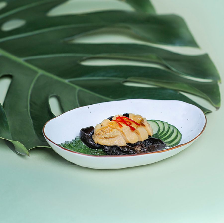 A plate of food next to a green leaf