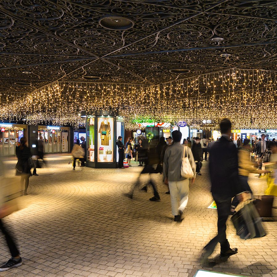 A group of shoppers walking through Tenjin Chikagai underground mall