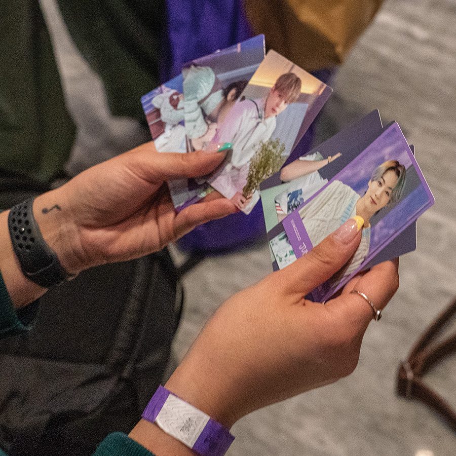 K-Pop fans holding mini-card