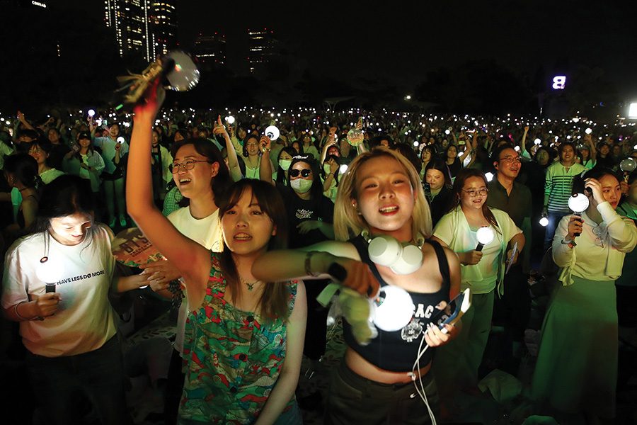 K-Pop fans holding lights