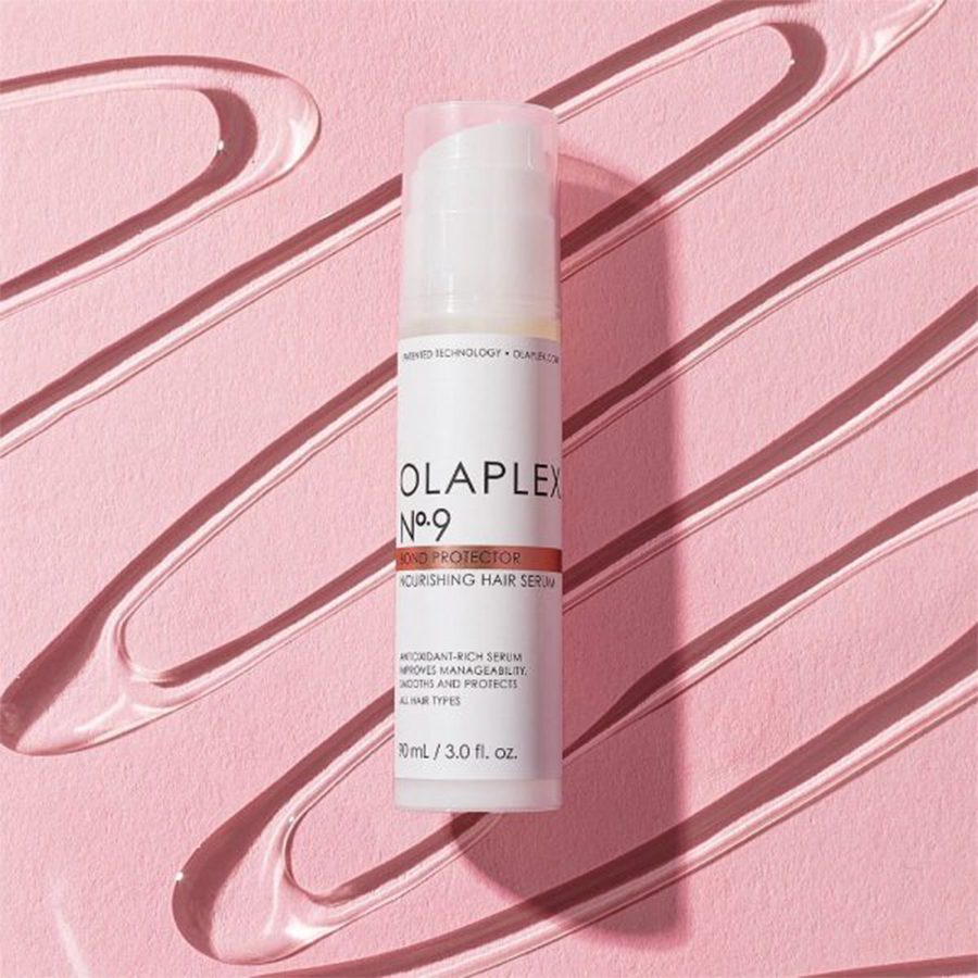 Olaplex hair serum in a bottle with pink background