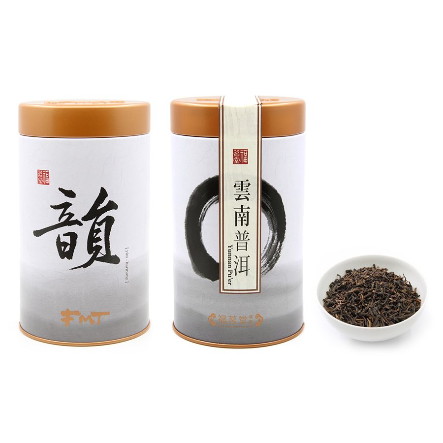 Two tins of Fook ming Tong Yunnan Puerh tea and loose leaf Puerh tea in a small white cup