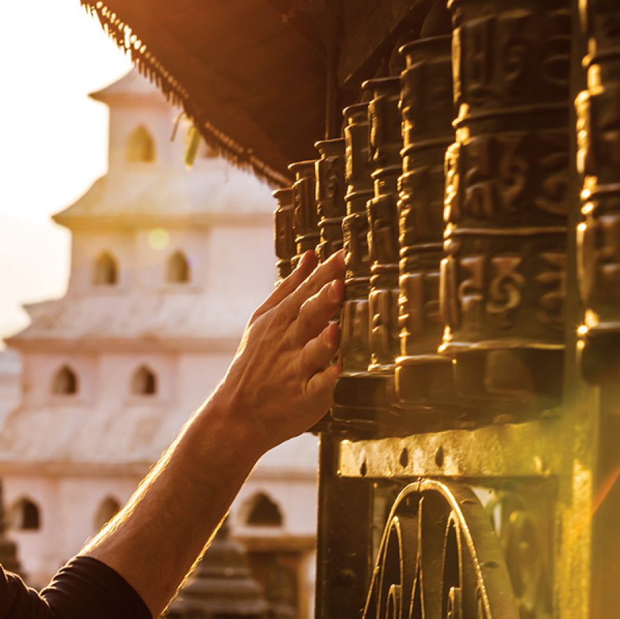 Spin prayer wheels at Boudhanath Stupa, Kathmandu. Credit: Getty Images