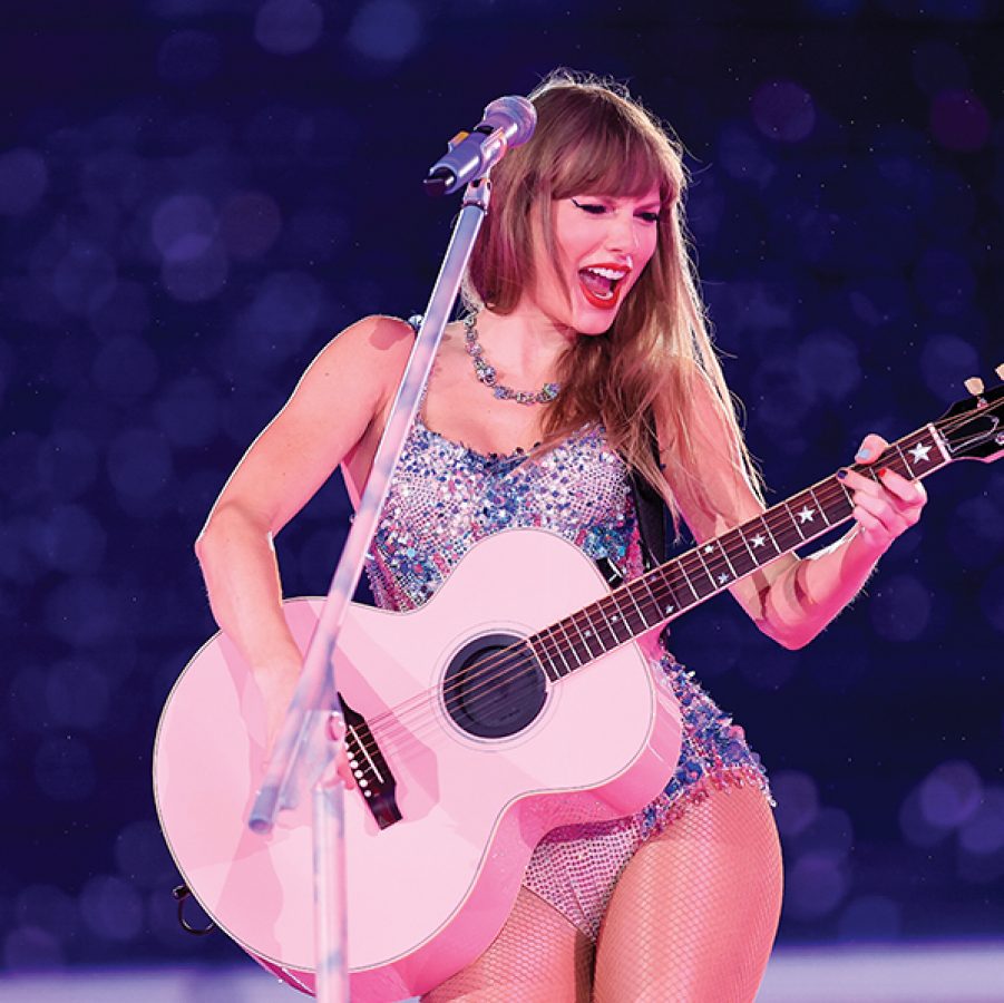 Taylor Swift with guitar on eras tour