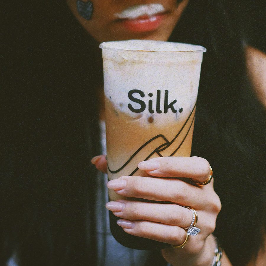 A girl drinking a cold beverage of bubble milk tea from Silk, Hong Kong