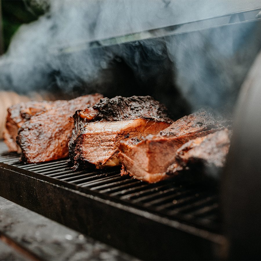 Meat sizzling on a barbecue.