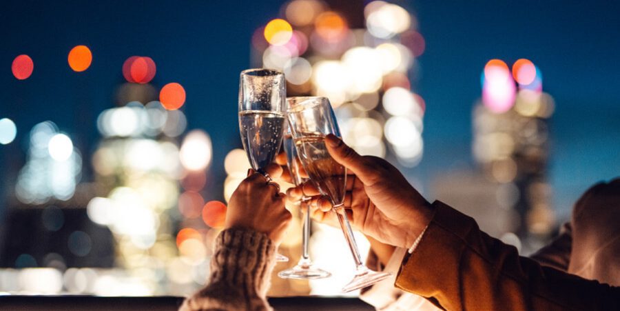 A group of people holding wine glasses